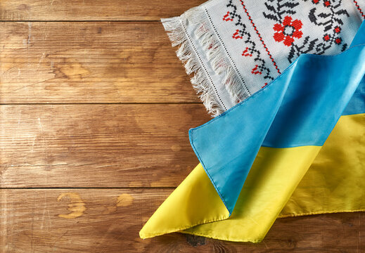 Ukrainian still life with traditional elements: flag of Ukraine, national embroidery and viburnum berries on a wooden background
