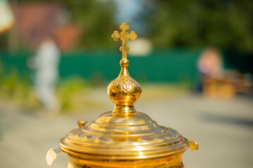 Orthodox cross on a gold object. Goldware for religious rites.
