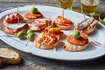 Assorted bruschettas served on table with beer