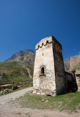 Fototapeta na wymiar Stone tower of the Balkarukovs in the village of Eltyubu in Kabardino-Balkaria in summer