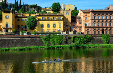 Sport activity on Arno river, residential historic townhouses along Lungarno Torrigiani, Florence, Tuscany, Italy, Europe