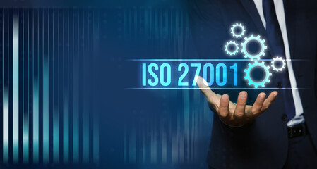 Naklejka na ściany i meble Man demonstrating virtual icon with text ISO 27001, closeup. Banner design