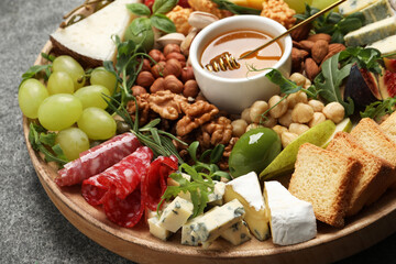 Different tasty appetizers on grey table, closeup