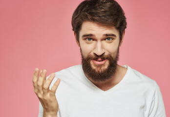 Obraz premium bearded man in a white t-shirt hand gestures anger Studio