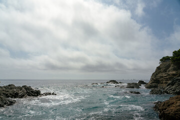 Fototapeta na wymiar sea beach and rocks with cloudy skies