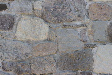 Fragment of the wall from natural stone of various shape