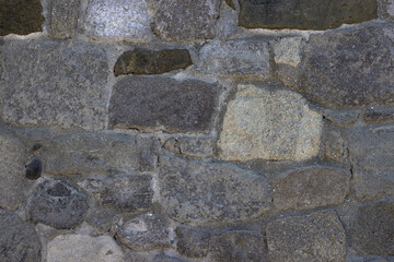 Fragment of the wall from natural stone of various shape