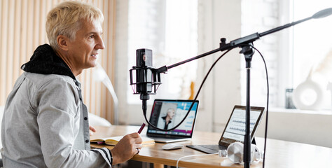 This person works in a radio studio. The radio host transmits the news and speaks into the...