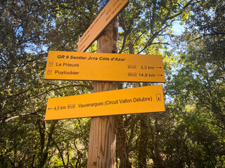 Wooden signposts indicating the GR9 trail leading to the Priory of Sainte-Victoire in Provence,...