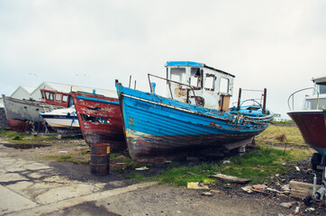 Fototapeta na wymiar Old fish-boat on sandy beach in Ireland