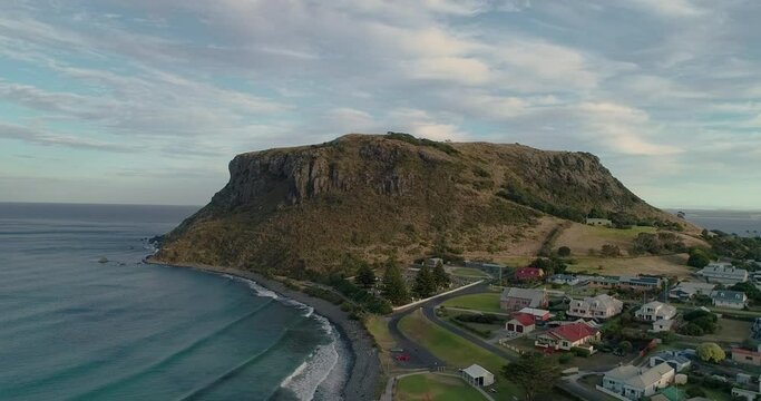 Ascending upward tracking aerial view of the township of Stanley and the ancient volcanic plug know as " The Nut", Stanley, Tasmania, Australia