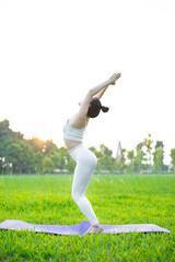 image of asian woman doing yoga outdoors