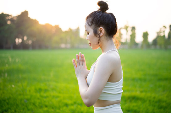 image of asian woman doing yoga outdoors