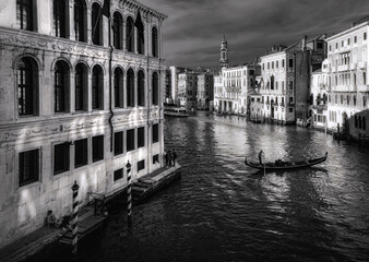 View of the canal from the Rialto Bridge in Venice. Boats and bridges. Veneto. Venice. Italy. Black and white.