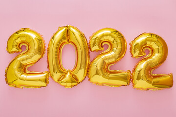 2022 balloons. 2022 girly pink gold bright lettering Happy New year eve celebration. Merry Christmas banner on pink color background