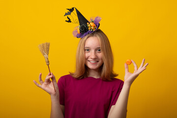 Funny young woman wearing witch costume for Halloween party. Happy Halloween witch with a black hat.