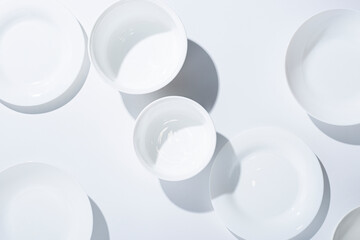 Empty white plates, dishes on a white background. Top view, flat lay