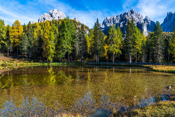 Autumn colors on the lake of Antorno. Magical glimpses of the Dolomites. Three peaks of Lavaredo