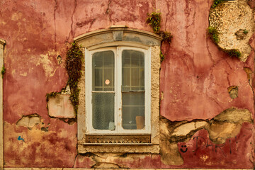 Picturesque window on an old red wall