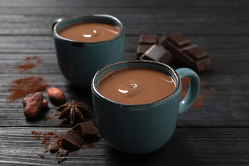 Yummy hot chocolate on black wooden table