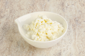Grained cottage cheese in the bowl