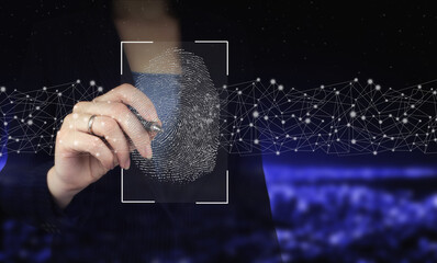 Password control through fingerprints. Hand holding digital graphic pen and drawing digital hologram fingerprint sign on city dark blurred background. Cyber security and data protection