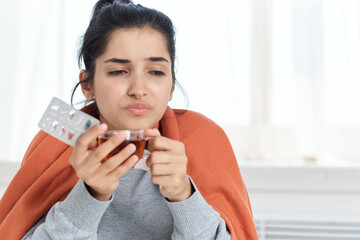 woman having a cold with a cup of tea medications treatment health problems