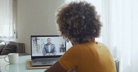 Fototapeta na wymiar African american woman at home working making a video call with a CEO. 