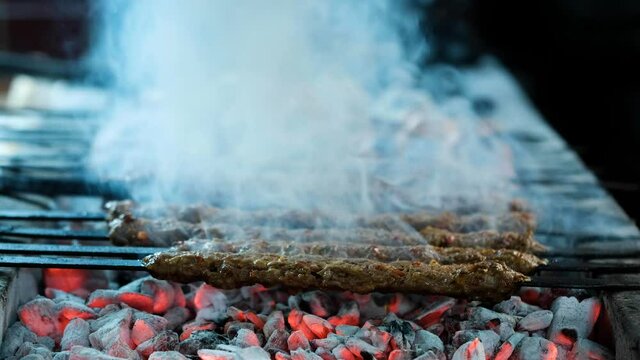Traditional Turkish Adana Kebab and Adana Kebap. Kebab or kebap on metal skewer barbecue in the kebap restaurant.