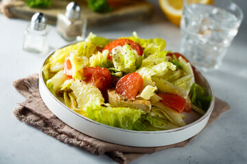 Healthy green salad with chicken and poached egg