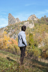 Naklejka na ściany i meble Man observes the landscape of the beautiful natural park 