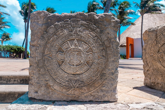 Cancun, Mexico. May 30, 2021. Close up of maya souvenirs carved on stone at pavement in resort. Ancient mayan carving on rocky stone