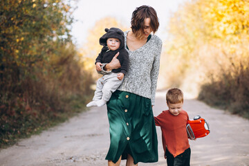 Young mother with two sons walking in park