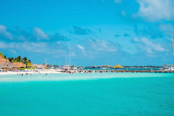 Cancun, Mexico. May 30, 2021. Yachts or sailboats sailing on beautiful turquoise sea water surface against cloudy sky