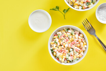 Salad with crab sticks, corn, eggs, cucumber and rice