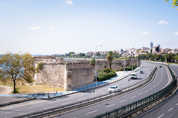 Zeytinburnu, Istanbul, Turkey - October 2021: Cars and historical walls on the coastal road of Istanbul. The historical land walls of Istanbul. Historical walls and highway in Zeytinburnu. 