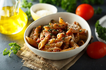 Homemade pasta with tomato sauce, parsley and cheese