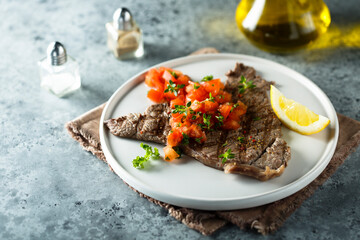 Grilled beef steak with tomato salsa