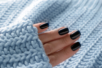 Dark blue winter manicure gel varnish on nails close-up.