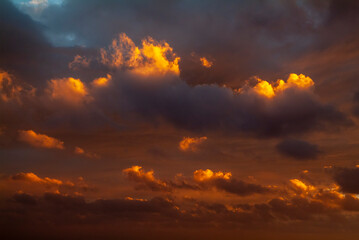 Colorful sunset sky with dramatic orange clouds. Only sky, no land.