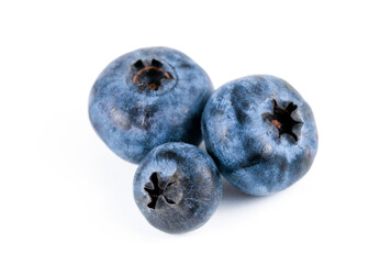 Obraz premium Three blueberries on a white background