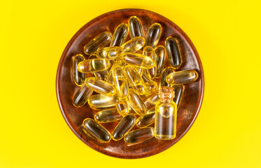 Omega-3 capsules on a colored background. Fish oil, healthy supplements