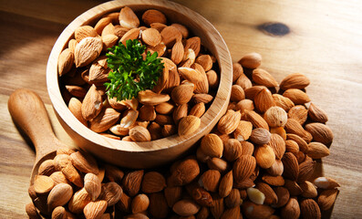 Bowl of apricot kernels on wooden table