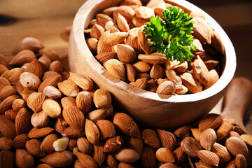 Bowl of apricot kernels on wooden table