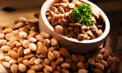 Bowl of apricot kernels on wooden table
