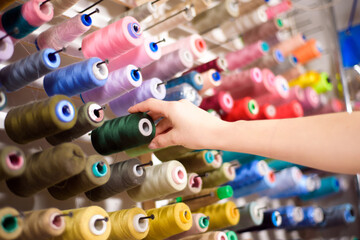 Colorful cones and spools of thread at an atelier.Tailoring, garment industry, designer workshop...