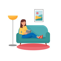woman reading a book sitting on the sofa