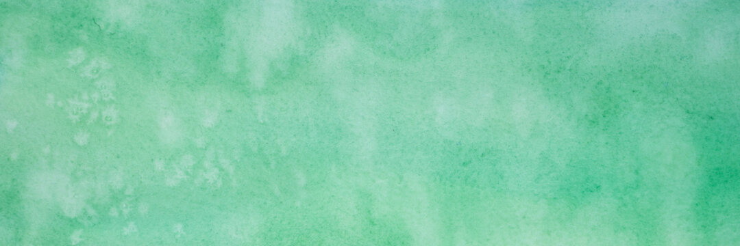 green watercolor with white spots. painted textured paper with watercolor paints of different green color. background or backdrop of abstract art handmade diy painting