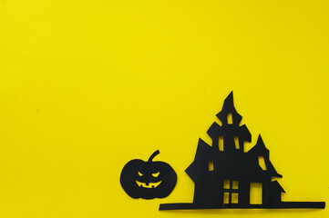 Halloween and decoration concept - bats, pumpkins, gloomy paper house, gloomy black tree branches on a yellow background. Folded paper origami art.
Halloween background with cut out
bats and other dec