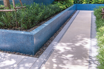 Outdoor walkway with granite tile flooring and terrazzo materials. Outdoor garden.